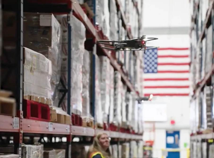 A Gather AI drone flying an inventory scan between warehouse racking